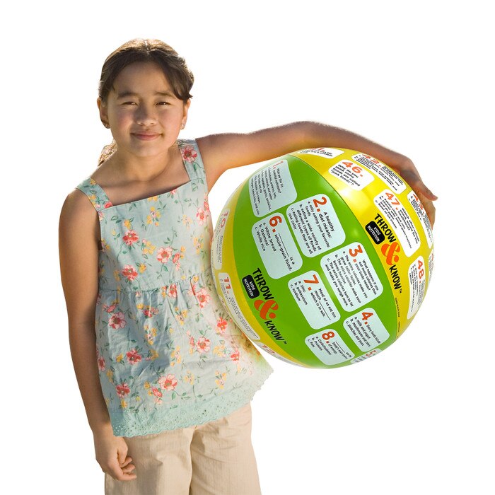 Child holding Kids Nutrition Throw & Know Activity Ball, health education inflatable ball with questions, Health Edco, 78007